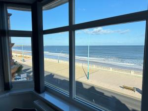 a view of the beach from a window at Seaviews Apartment 2, Whitley Bay Sea Front in Whitley Bay