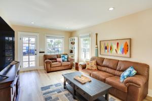 a living room with a couch and a table at Huntington Beach Hideaway Near Beach and Downtown! in Huntington Beach