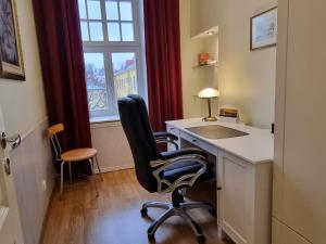 a room with a desk with a sink and a chair at Classic Apartments in Old Town in Tallinn