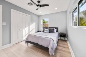 1 dormitorio con 1 cama y ventilador de techo en Coastal Charm + Modern Comfort Delray! en Delray Beach