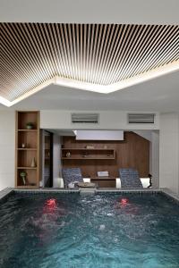 a swimming pool in a building with a ceiling at Vila Danica in Jahorina