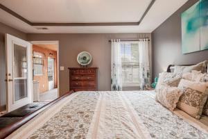 a bedroom with a large bed and a window at Hot Tub Hideaway 3 BR in Jeffersonville +19 photos