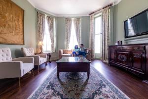 a man sitting on a couch in a living room at 1886 Crescent Hotel and Spa in Eureka Springs