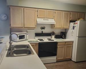 a kitchen with a sink and a stove and refrigerator at Tilghman Shores D9 in Myrtle Beach
