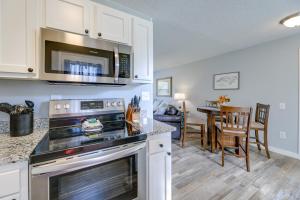 a kitchen with a stove and a microwave at New Bern Abode with Yard about 2 Mi to Neuse River in New Bern