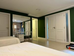 a bedroom with green and white walls and a bed at OKA Praia Cabeçudas & SPA in Itajaí