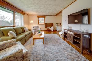 a living room with a couch and a table at Mayville Vacation Rental - Walk to Chautauqua Lake in Mayville