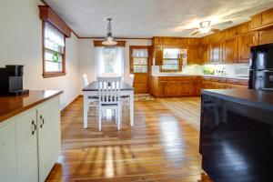 a kitchen with a white table and chairs in it at Mayville Vacation Rental - Walk to Chautauqua Lake in Mayville