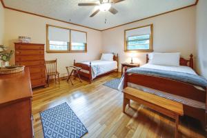 a bedroom with two beds and a dresser at Mayville Vacation Rental - Walk to Chautauqua Lake in Mayville