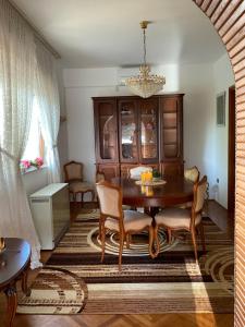 a dining room with a table and chairs and a chandelier at Villa Feodora in Biograd na Moru