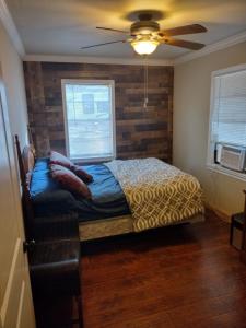 a bedroom with a bed and a brick wall at Rustic house on Lake Tawakoni in Hawk Cove