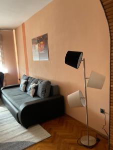 a living room with a black couch and a lamp at Villa Feodora in Biograd na Moru