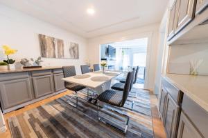 a kitchen and dining room with a table and chairs at Cityscape Haven - Central SF Home near SFO in San Bruno