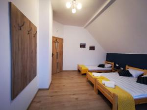a room with two beds and a hallway at Apartamenty Starosądeckie in Stary Sącz