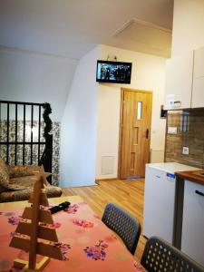 a living room with a table and a television on the wall at Apartamenty Starosądeckie in Stary Sącz +20 photos