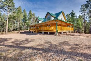 een groot houten huis met een groen dak bij Private Ski-Out Angel Fire Cabin Wraparound Porch in Angel Fire