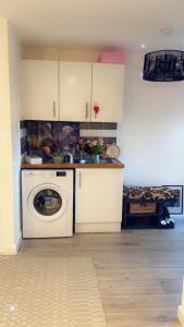a kitchen with a washing machine and a washer at Stay in Woking with Chidi in Horsell