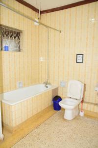a bathroom with a bath tub and a toilet at Jabulani Nairobi Backpackers Hostel in Nairobi