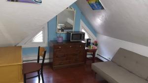 a living room with a couch and a tv at West End Haven in Hartford