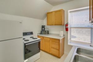 a small kitchen with a stove and a refrigerator at Convenient Logan Apartment - 1 Block to Town! in Logan