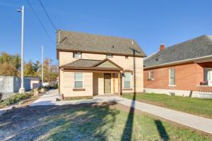 a brick house with a driveway in front of it at Convenient Logan Apartment - 1 Block to Town! in Logan