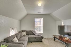 a living room with a couch and a flat screen tv at Convenient Logan Apartment - 1 Block to Town! in Logan