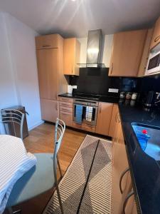 a small kitchen with a glass counter and a table at 2 Bedroom flat in Leicester Square in London