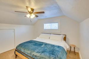 una camera da letto con un letto e un ventilatore a soffitto di Convenient Logan Apartment - 1 Block to Town! a Logan