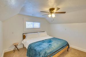 a bedroom with a bed and a ceiling fan at Convenient Logan Apartment - 1 Block to Town! in Logan