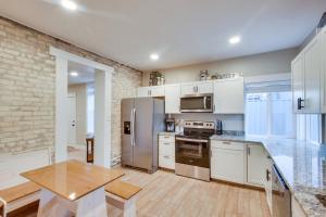 a kitchen with a stainless steel refrigerator and a table at Stylish Logan Retreat with Smart TV and Central A and C! in Logan