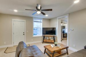 a living room with a couch and a ceiling fan at Stylish Logan Retreat with Smart TV and Central A and C! in Logan