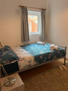 a bed sitting in a room with a window at 2 Bedroom flat in Leicester Square in London