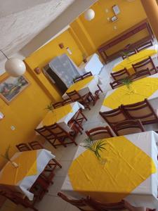 an overhead view of a restaurant with tables and yellow umbrellas at Pousada Recanto da Vila in Trancoso