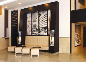 a lobby with a table and chairs and a picture on the wall at Riu Plaza Miami Beach in Miami Beach
