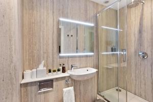 a bathroom with a sink and a shower at Fountains Guest House - Harrogate Stays in Harrogate