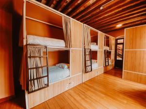 a room with three bunk beds in a house at Viajero Quito Hostel in Quito