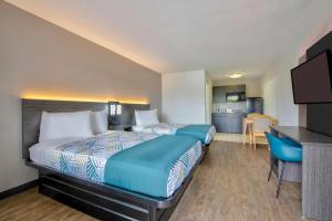a hotel room with two beds and a kitchen at Studio 6 Extended Stay - Pascagoula, MS in Pascagoula +17 photos
