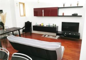 a living room with a couch and a tv at Loft station in Guimarães