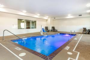 a large swimming pool in a room with at Comfort Inn and Suites Van Buren - Fort Smith in Van Buren