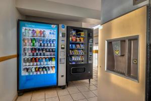 a soda vending machine in a building at Motel 6 Stuart, Ia in Stuart