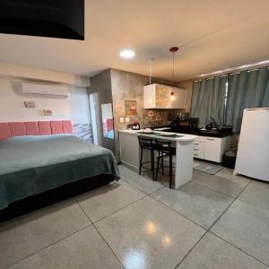 a bedroom with a bed and a kitchen with a counter at STUDIO 204 | WIFI 600MB | RESIDENCIAL JC, um lugar para ficar. in Belém