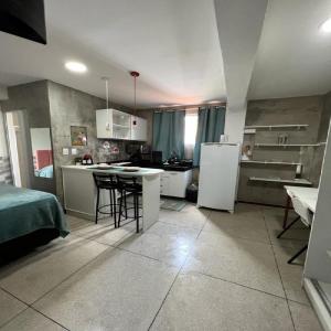 a kitchen with a refrigerator and a table in it at STUDIO 204 | WIFI 600MB | RESIDENCIAL JC, um lugar para ficar. in Belém