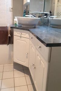 a bathroom with a white sink and a counter at Apartment in Chessy very near Disneyland in Chessy +16 photos