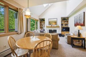 a living room with a table and chairs at Highridge J5B Spectacular 1 Bedroom Escape with fireplace, sauna & resort amenities in Killington