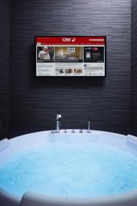 a bathroom with a sink and a website on the wall at Gregorio VII Luxury Suites in Rome