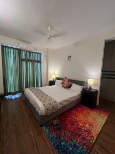 a bedroom with a large bed and a rug at Panorama Haven With Swimming Pool in Lucknow