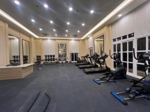 a gym with a row of treadmills and exercise bikes at Panorama Haven With Swimming Pool in Lucknow