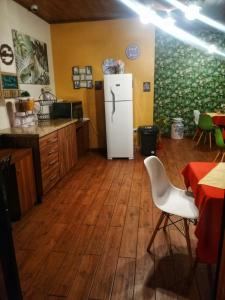 a kitchen with a white refrigerator in a room at Hotel Cabañas y Mirador Secret Garden CR in Cartago