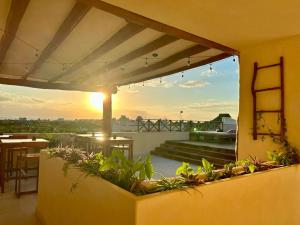 a balcony with a view of the sunset at sunsteps dragonfly room in Holbox Island