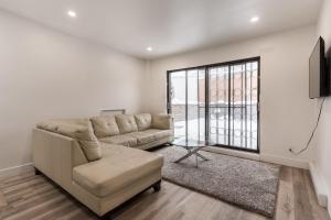 a living room with a couch and a window at Spacious 2 bedroom apartment - 02 in Montreal